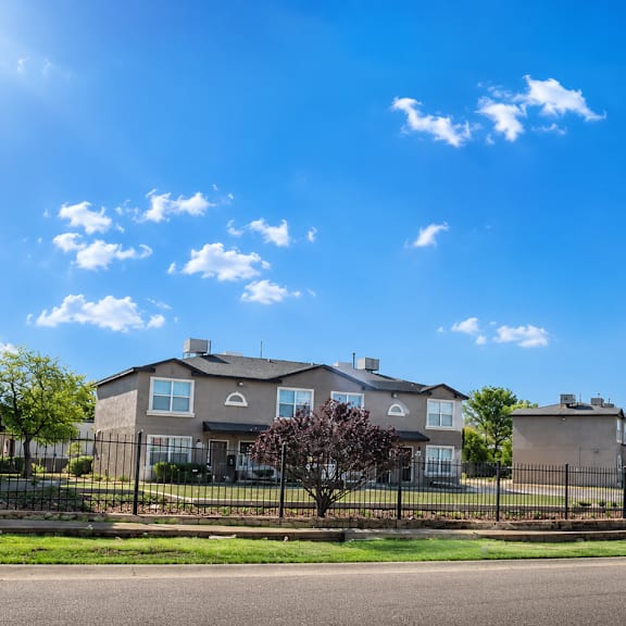 a row of houses with a clear blue sky above them.