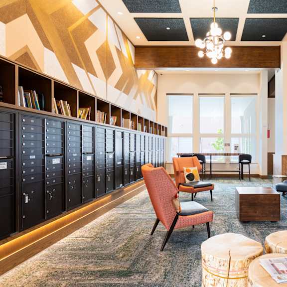 a room with a carpeted floor and a wooden ceiling with a chandelier.