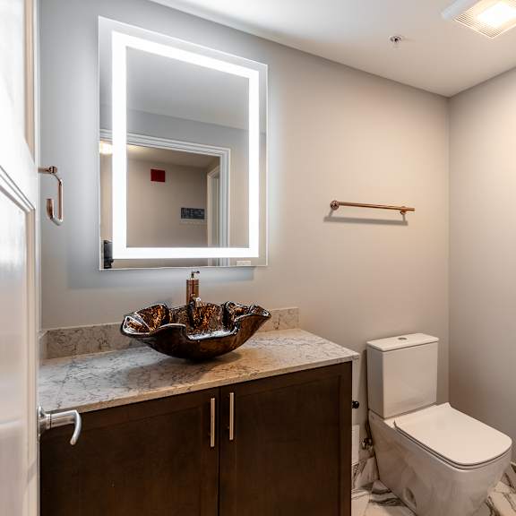 Thumbnail 8 of 14 a small bathroom with a mirror and a toilet at Park Heights by the Lake Apartments, Chicago, Illinois