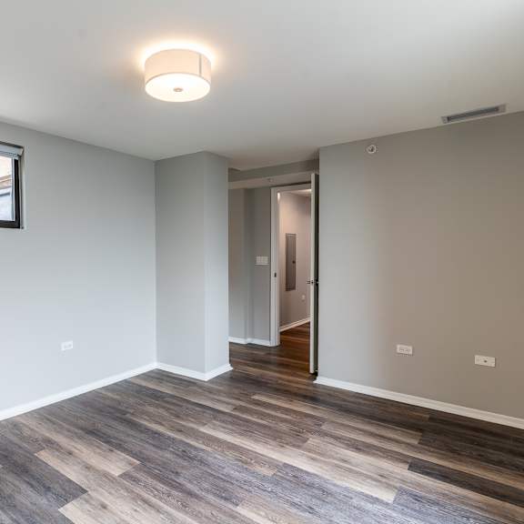 Thumbnail 10 of 14 a living room with wood flooring and a large window at Park Heights by the Lake Apartments, Chicago