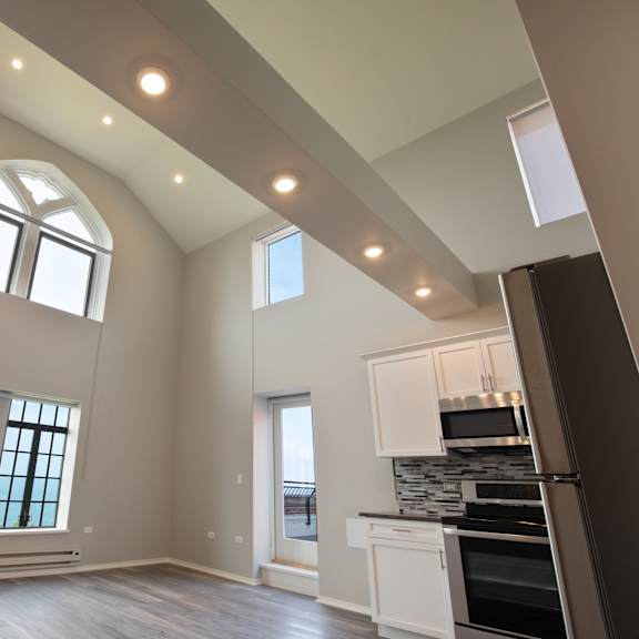 Thumbnail 5 of 14 a kitchen and living room with high ceilings and windows at Park Heights by the Lake Apartments, Chicago, 60649