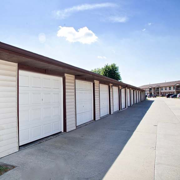 a long row of white garage doors are closed.