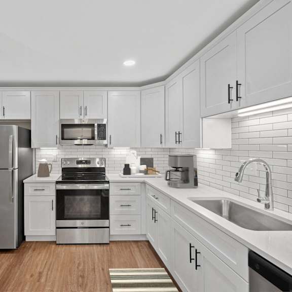 Thumbnail 3 of 14 a white kitchen with stainless steel appliances and white cabinets at Indian Creek Apartments*, Cincinnati, Ohio