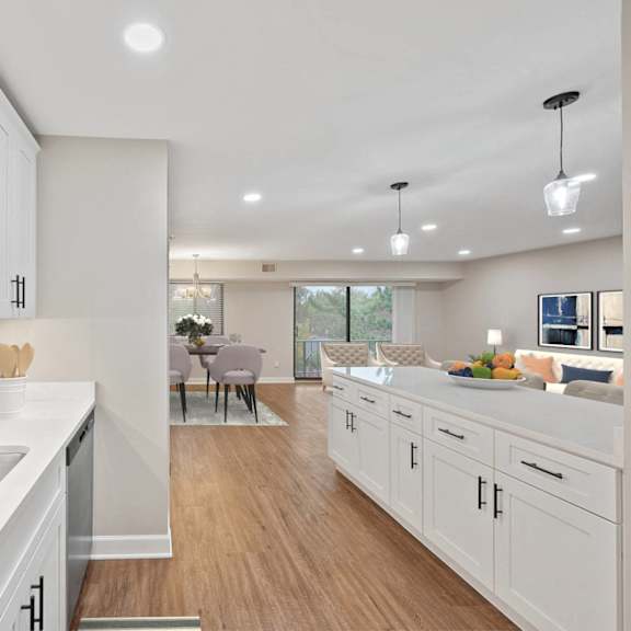 Thumbnail 4 of 14 an open kitchen and living room with a large sink and white cabinets at Indian Creek Apartments*, Ohio