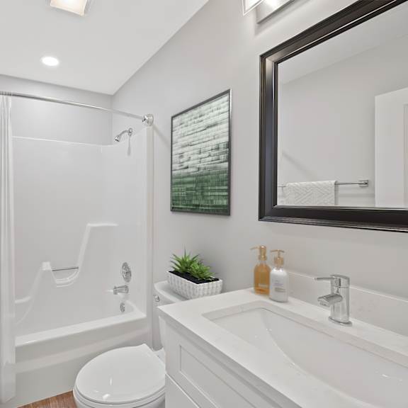 Thumbnail 15 of 18 A white bathroom with a toilet, sink, and shower. at Indian Creek Apartments*, Ohio, 45236