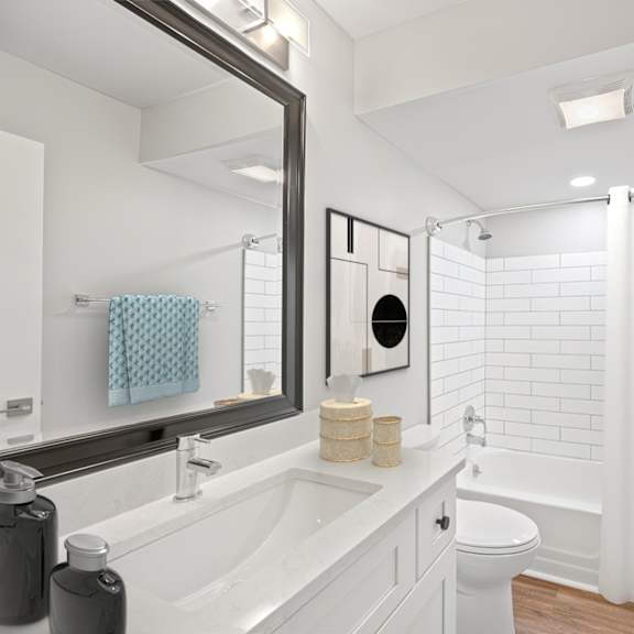 Thumbnail 12 of 25 A white bathroom with a white tub and toilet. at Indian Creek Apartments*, Cincinnati, Ohio