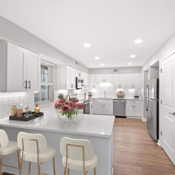 Thumbnail 9 of 25 A modern kitchen with white cabinets and a central island. at Indian Creek Apartments*, Cincinnati, OH, 45236
