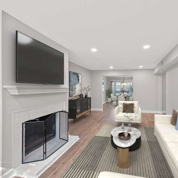Thumbnail 5 of 25 A modern living room with a fireplace and a flat screen TV. at Indian Creek Apartments*, Ohio