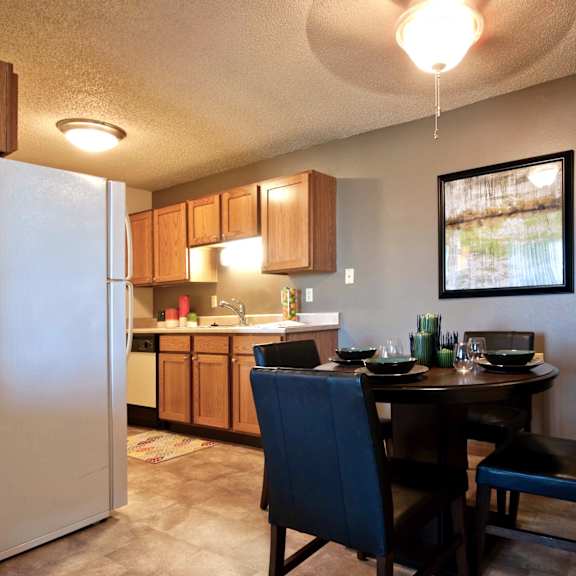 a kitchen with a dining table and chairs.
