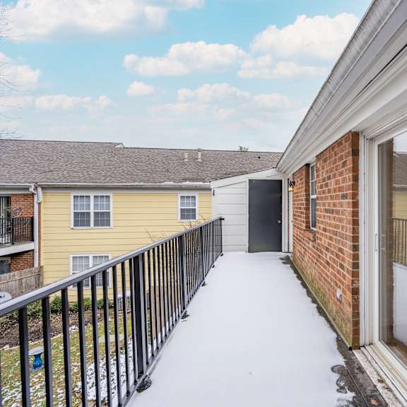 Thumbnail 22 of 22 Balcony with a brick building and a yellow house at Indian Creek Apartments*, Ohio
