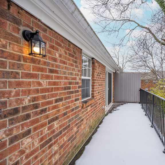 Thumbnail 21 of 22 Deck of a brick house with a black railing and a brick wall at Indian Creek Apartments*, Ohio, 45236