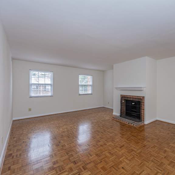 Thumbnail 14 of 22 Empty living room with a fireplace and wooden floors at Indian Creek Apartments*, Cincinnati