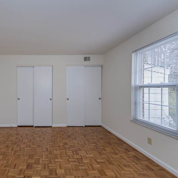 Thumbnail 16 of 22 Living room with wood flooring and white walls and doors at Indian Creek Apartments*, Ohio