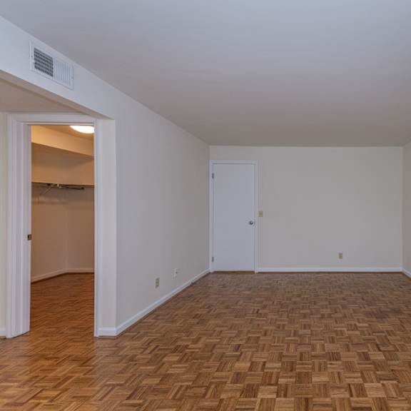 Thumbnail 17 of 22 Empty living room with wood flooring and white walls at Indian Creek Apartments*, Ohio