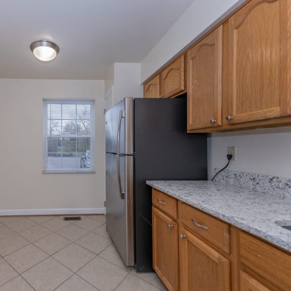 Thumbnail 7 of 21 an empty kitchen with a refrigerator and a window at Indian Creek Apartments*, Cincinnati, OH