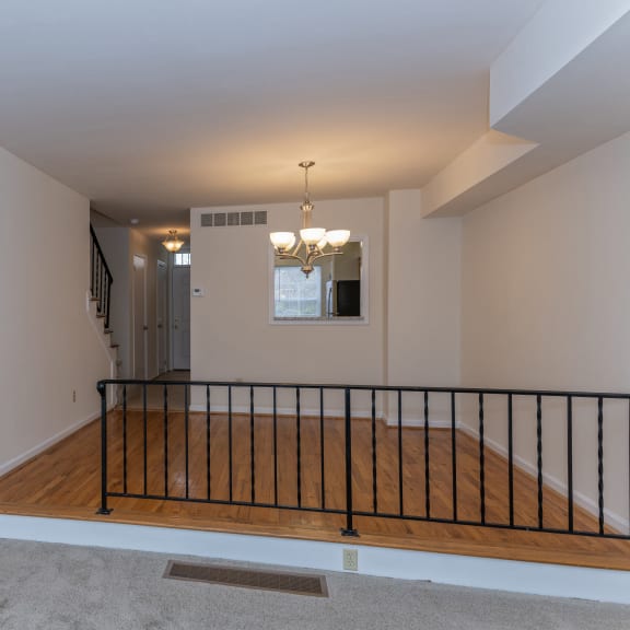 Thumbnail 10 of 21 an empty living room with a staircase and a wooden floor at Indian Creek Apartments*, Cincinnati, OH