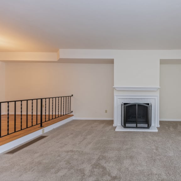 Thumbnail 12 of 21 an empty living room with a fireplace and a window at Indian Creek Apartments, Cincinnati, OH, 45236