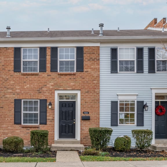Thumbnail 3 of 21 a white house with black doors and a red brick facade at Indian Creek Apartments*, Cincinnati, Ohio