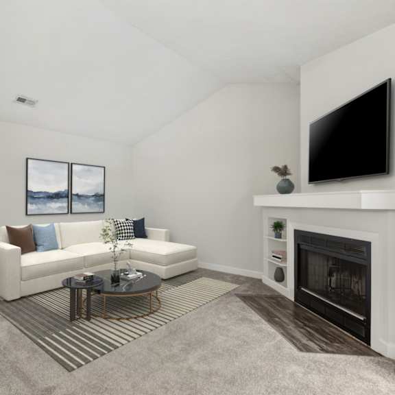a living room with a white couch, a fireplace, and a painting on the wall.