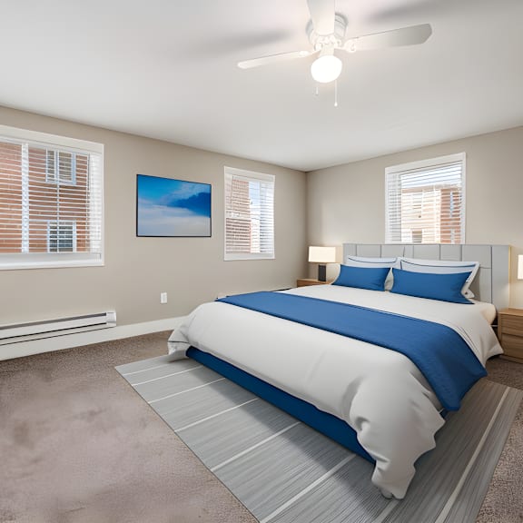 a bedroom with a bed and a ceiling fan