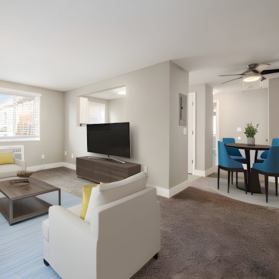 a living room with white furniture and a television