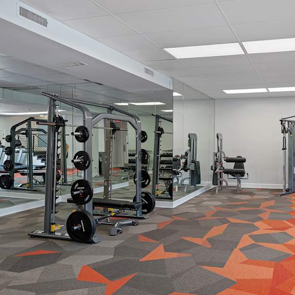 a gym with orange and grey floor tiles.