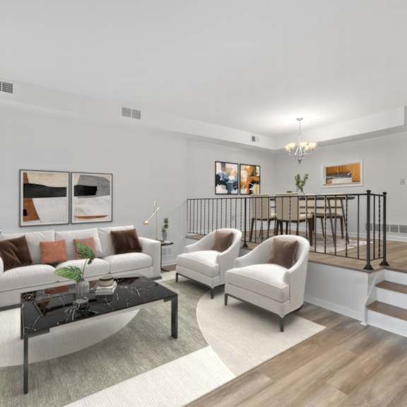 Thumbnail 3 of 12 A living room with a white couch, a black coffee table, and a staircase with a black railing.