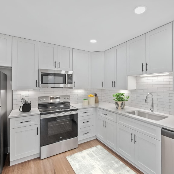 Thumbnail 4 of 10 a white kitchen with stainless steel appliances and white cabinets at Indian Creek Apartments*, Cincinnati, OH, 45236