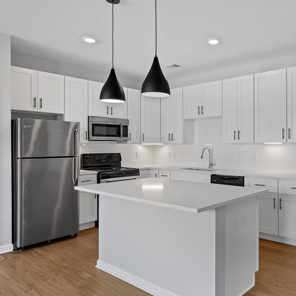 Thumbnail 4 of 19 a large white kitchen with white cabinets and stainless steel appliances at Monmouth Row Apartments, Newport, Kentucky