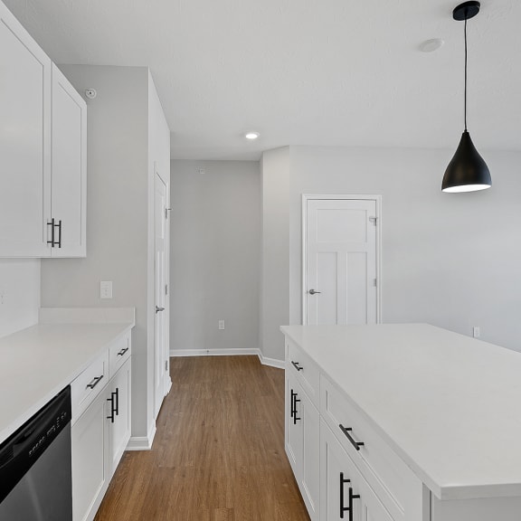 Thumbnail 6 of 19 a renovated kitchen with white cabinets and white counter tops at Monmouth Row Apartments, Newport, 41071