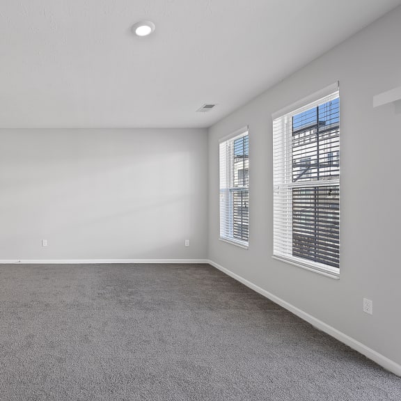Thumbnail 10 of 19 an empty living room with white walls and wood flooring at Monmouth Row Apartments, Newport, Kentucky