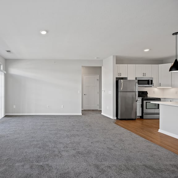 Thumbnail 9 of 19 an empty living room and kitchen with a large window at Monmouth Row Apartments, Newport, 41071