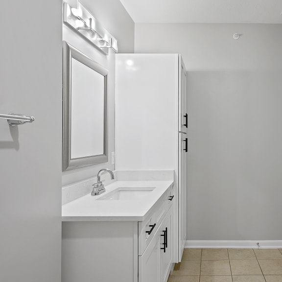 Thumbnail 18 of 19 an empty bathroom with a sink and a refrigerator at Monmouth Row Apartments, Newport, Kentucky
