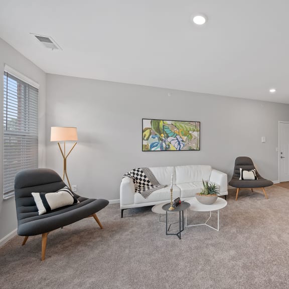 Thumbnail 9 of 15 an open living room and kitchen with a couch and chairs at Monmouth Row Apartments, Newport, 41071