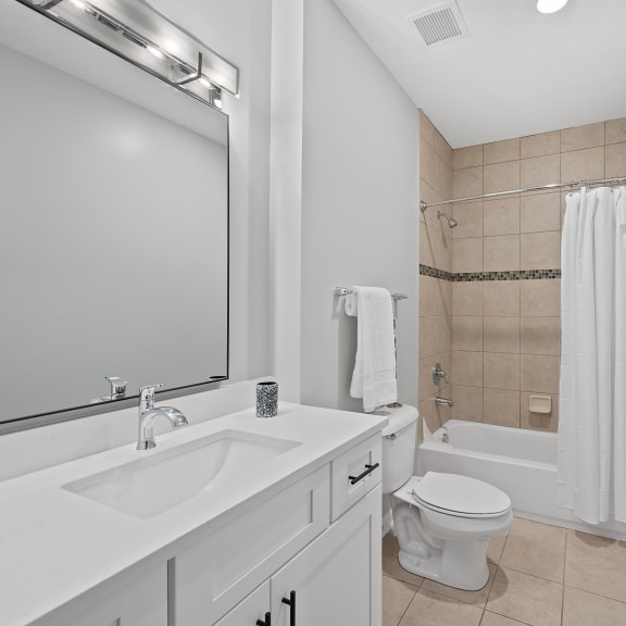 Thumbnail 12 of 15 a bathroom with a sink toilet and a shower at Monmouth Row Apartments, Newport, KY