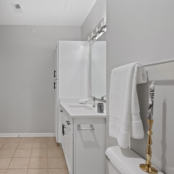 Thumbnail 13 of 15 a small bathroom with a sink and a refrigerator at Monmouth Row Apartments, Newport, Kentucky