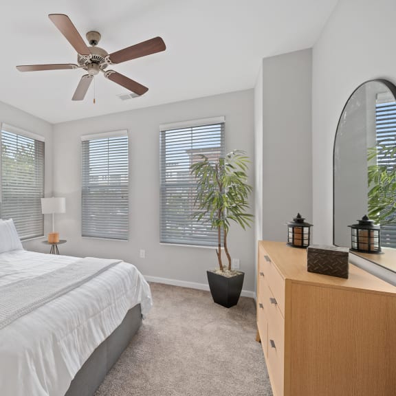 Thumbnail 10 of 15 a bedroom with a large bed and a ceiling fan at Monmouth Row Apartments, Newport, 41071