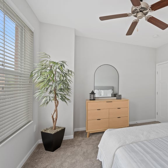 Thumbnail 11 of 15 a bedroom with a bed and a ceiling fan at Monmouth Row Apartments, Newport, 41071