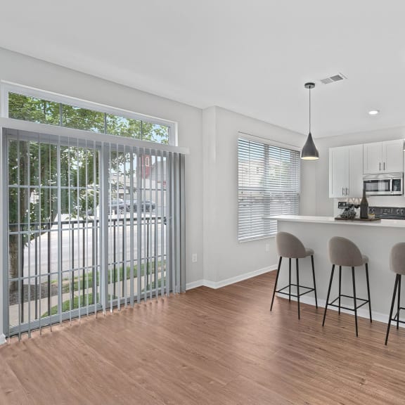 Thumbnail 4 of 7 a kitchen with a bar and a sliding glass door at Monmouth Row Apartments, Newport, 41071