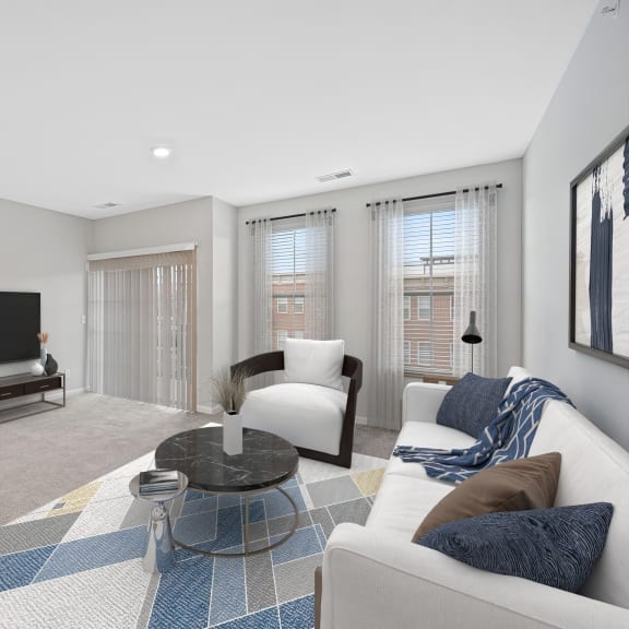 Thumbnail 6 of 8 a living room with a couch and a chair and a television at Monmouth Row Apartments, Newport, KY, 41071