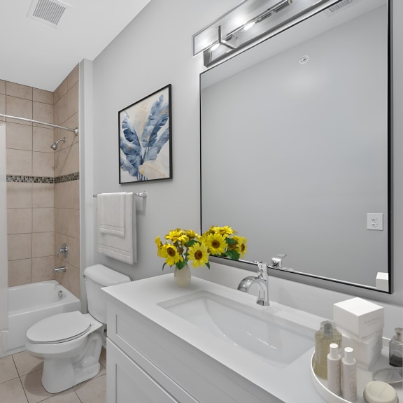 Thumbnail 6 of 6 a bathroom with a sink and a toilet and a shower at Monmouth Row Apartments, Newport, Kentucky