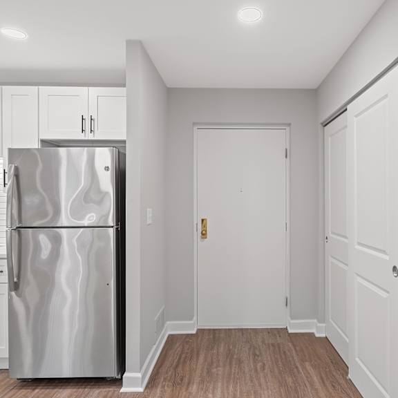 Thumbnail 13 of 18 A kitchen with a refrigerator, sink, and cabinets. at Indian Creek Apartments*, Ohio
