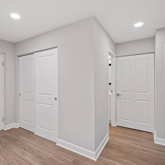 Thumbnail 12 of 18 A room with white walls and wooden flooring with three doors. at Indian Creek Apartments*, Cincinnati, OH