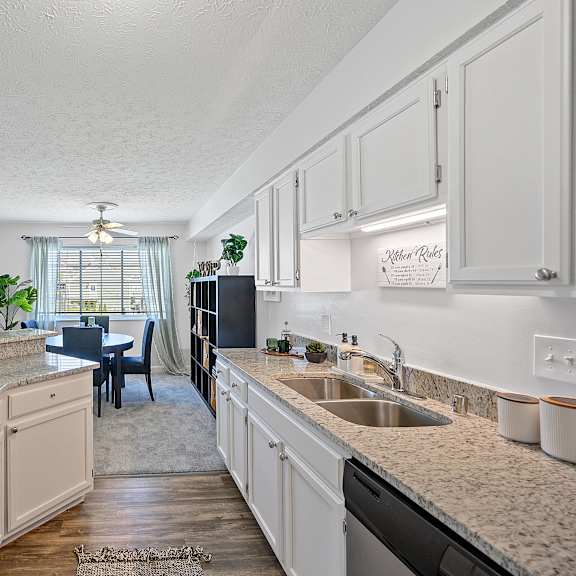 spacious kitchen with granite counter tops and a dining room with a table and chairs at wrights point, 41011