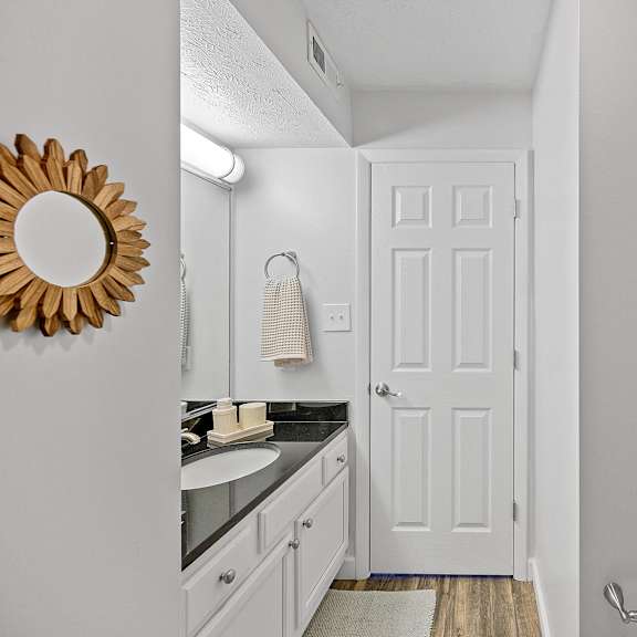 bathroom with a white door and a sink and a mirror at wrights point, ft wright