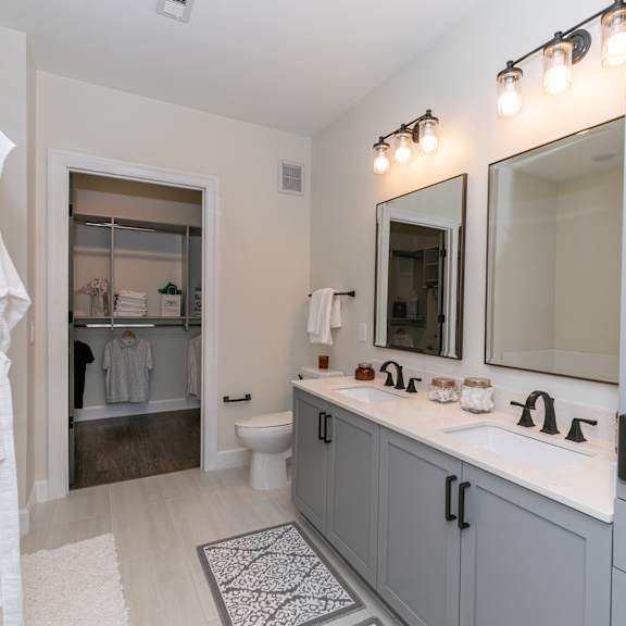 Thumbnail 4 of 8 A bathroom with a white towel hanging on a door.