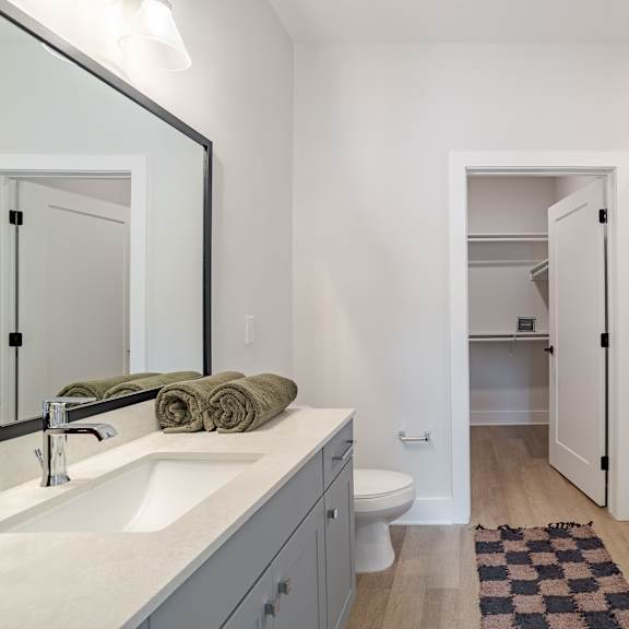 modern bathroom with walk in shower and vanity at the yancey apartments, charlotte, 28217