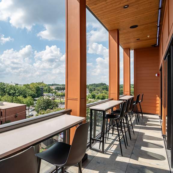 rooftop balcony with bar height seating and skyline views at the yancey apartments, charlotte, nc 28217