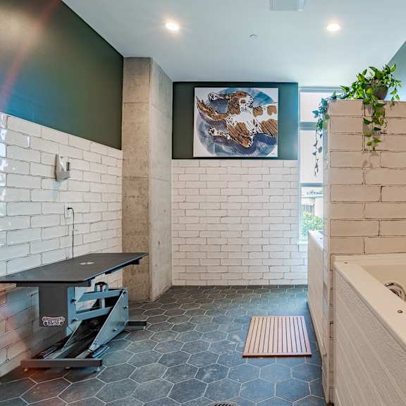 spa bathroom with soaking tub and white brick walls at the yancey apartments, charlotte