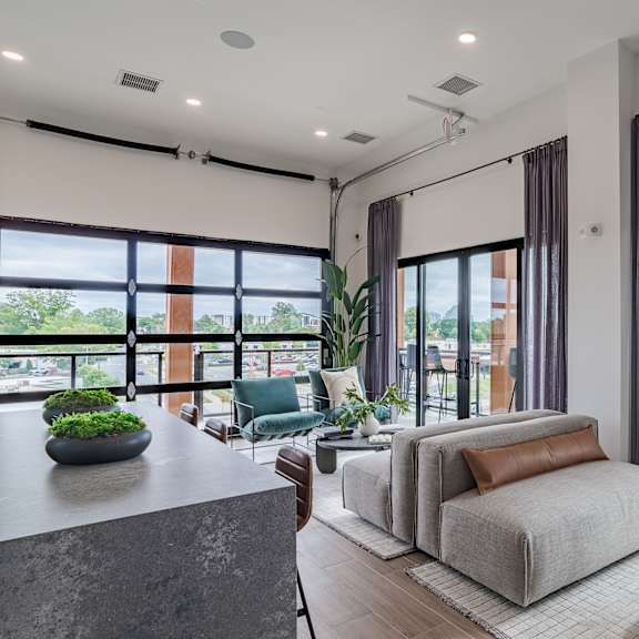 open concept living area with floor to ceiling windows at the yancey apartments, north carolina, 28217